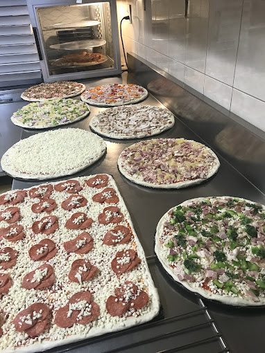 Fresh pizzas prepped and ready for the oven