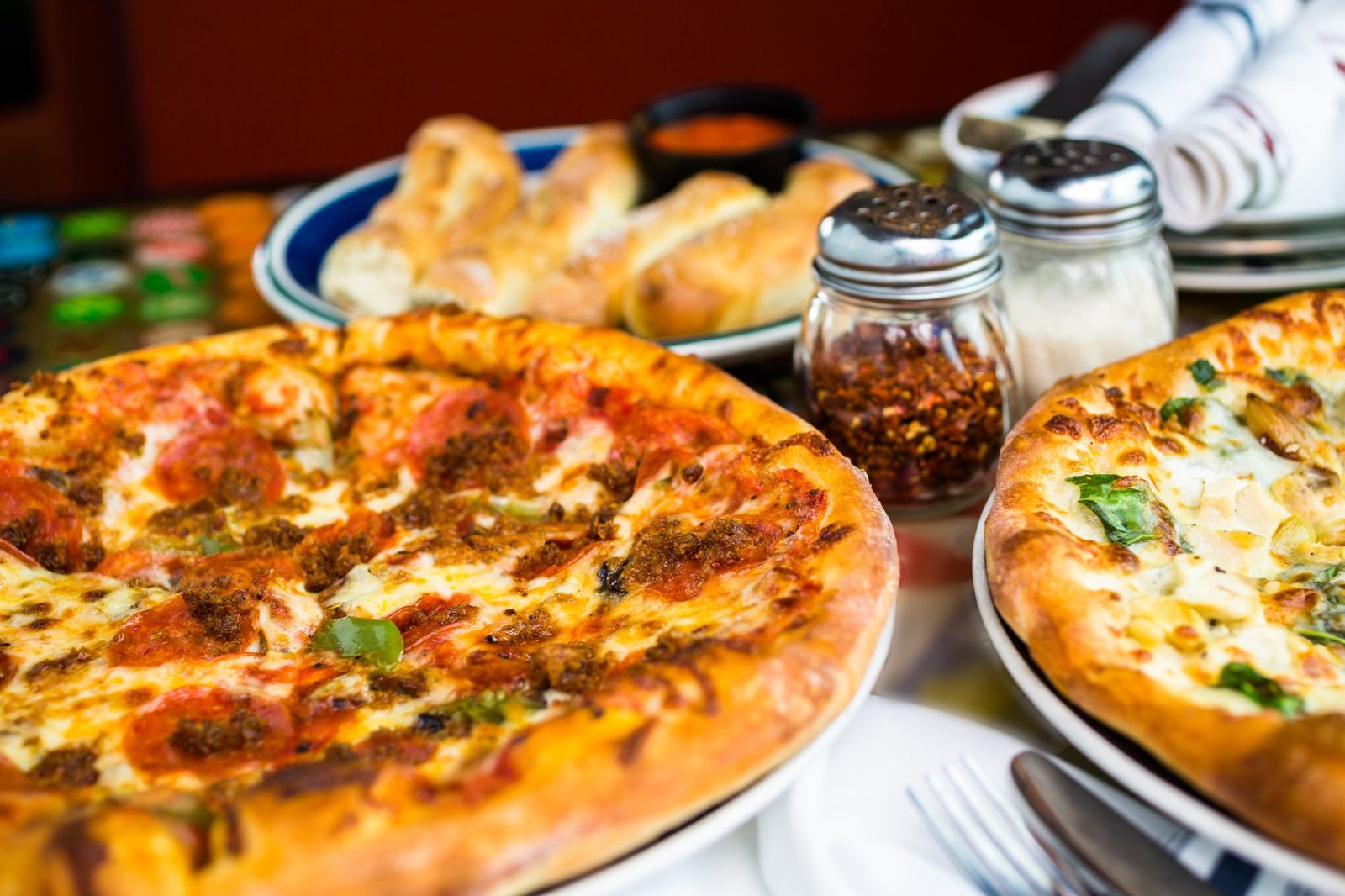 Pizzas and breadsticks on the table